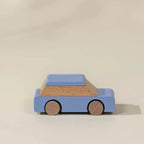 Wooden urban play car in blue with wooden wheels, side view