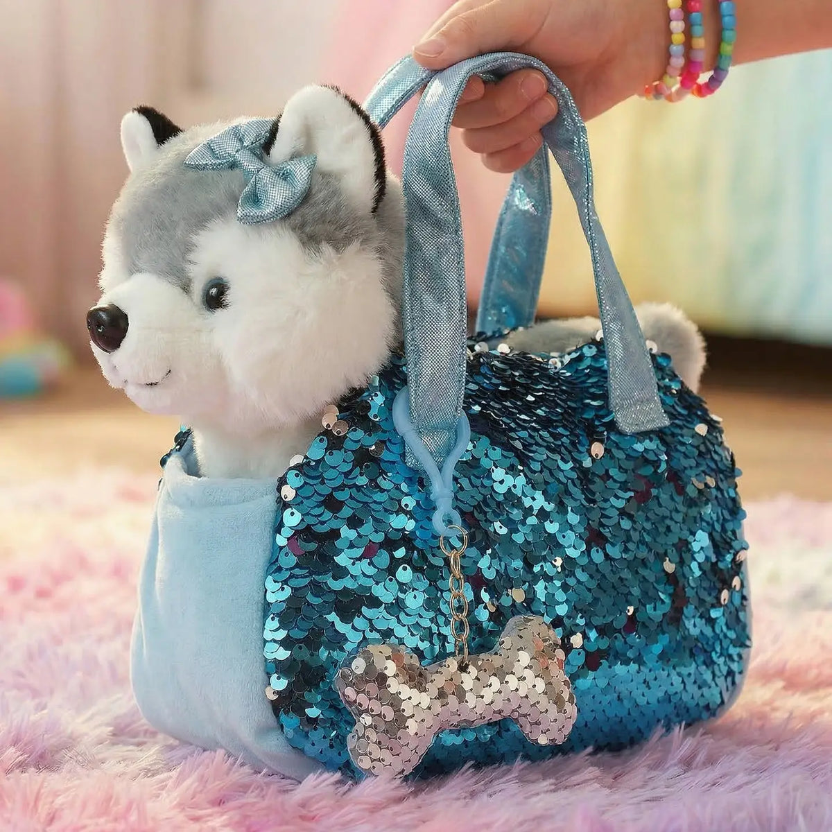 Little Jupiter husky plush in a blue sequin pet carrier bag with bone charm