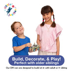 Two kids playing with a decorated DIY wooden monster truck