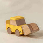 Wooden yellow bulldozer with raised front loader scoop, angled view