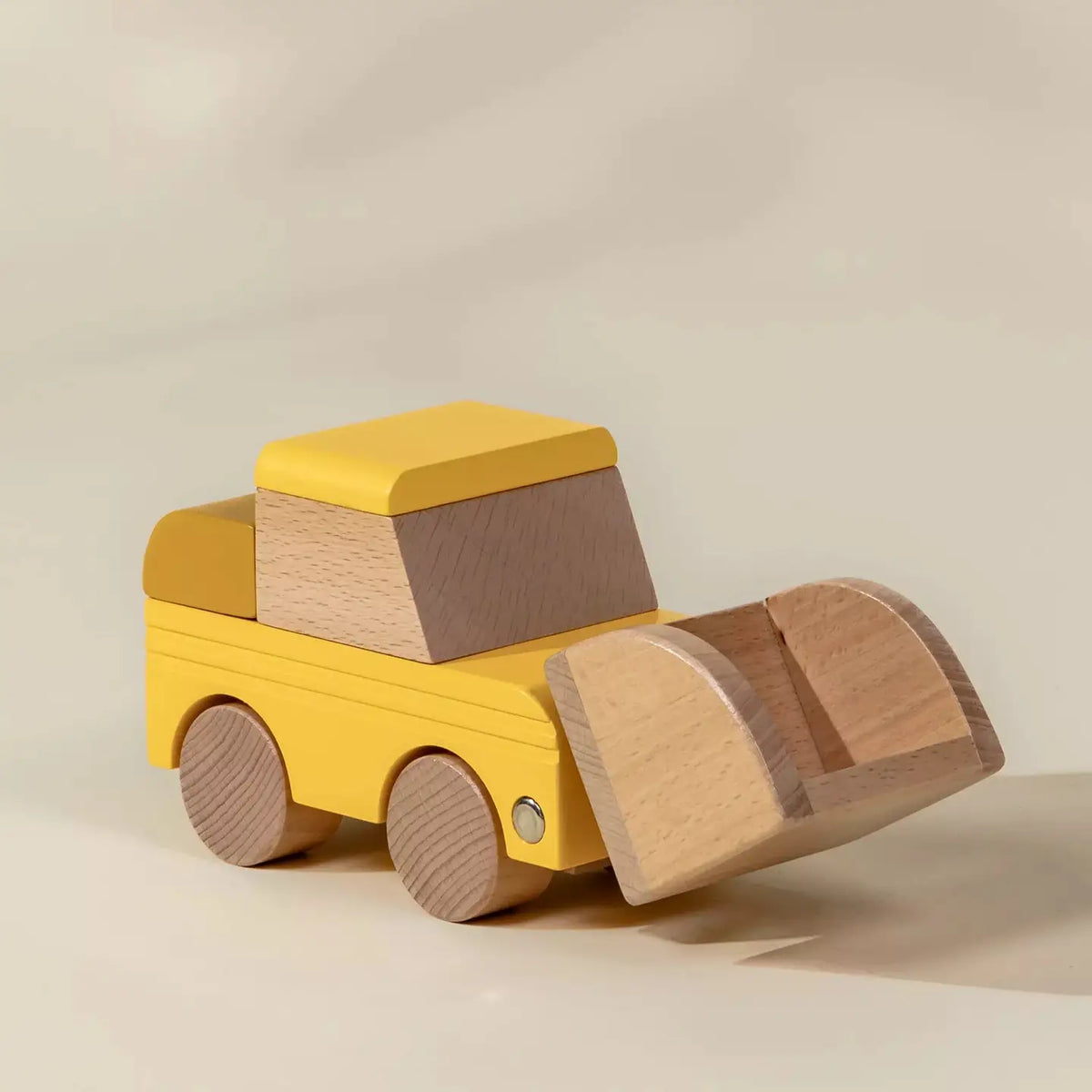 Wooden yellow bulldozer with raised front loader scoop, angled view