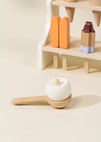 Coco Village wooden ice cream stand with popsicles and a scoop holding a toy ice cream