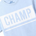 Close-up of light blue Chopper Club boys tee with large white CHAMP graphic