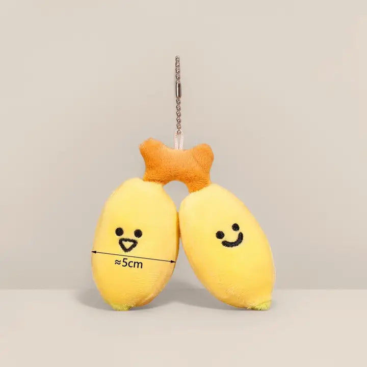 Two-banana plush keychain charm with smiling faces on a ball chain