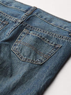 Close-up of back pocket stitching on medium-wash boys straight leg jeans