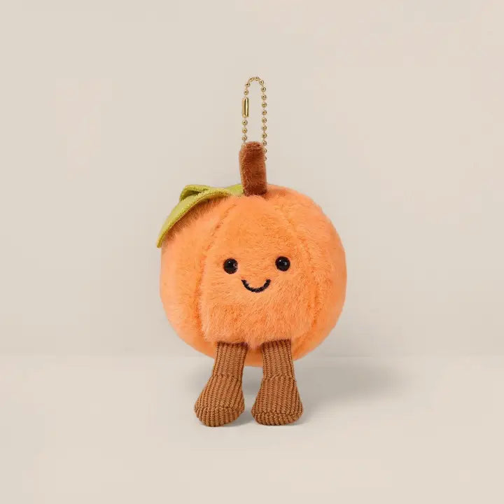 Fuzzy peach plush keychain charm with leaf and corduroy legs