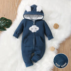 Navy cloud hooded fleece baby romper with front zip and pom-pom ears, flat lay