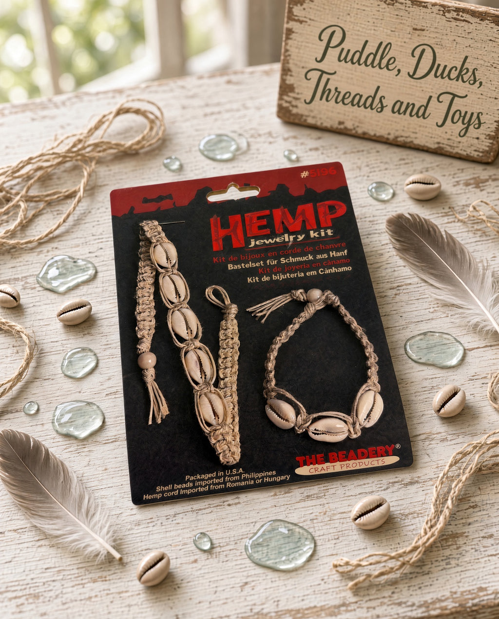 Hemp jewelry kit with cowrie shell bracelet displayed with twine and shells
