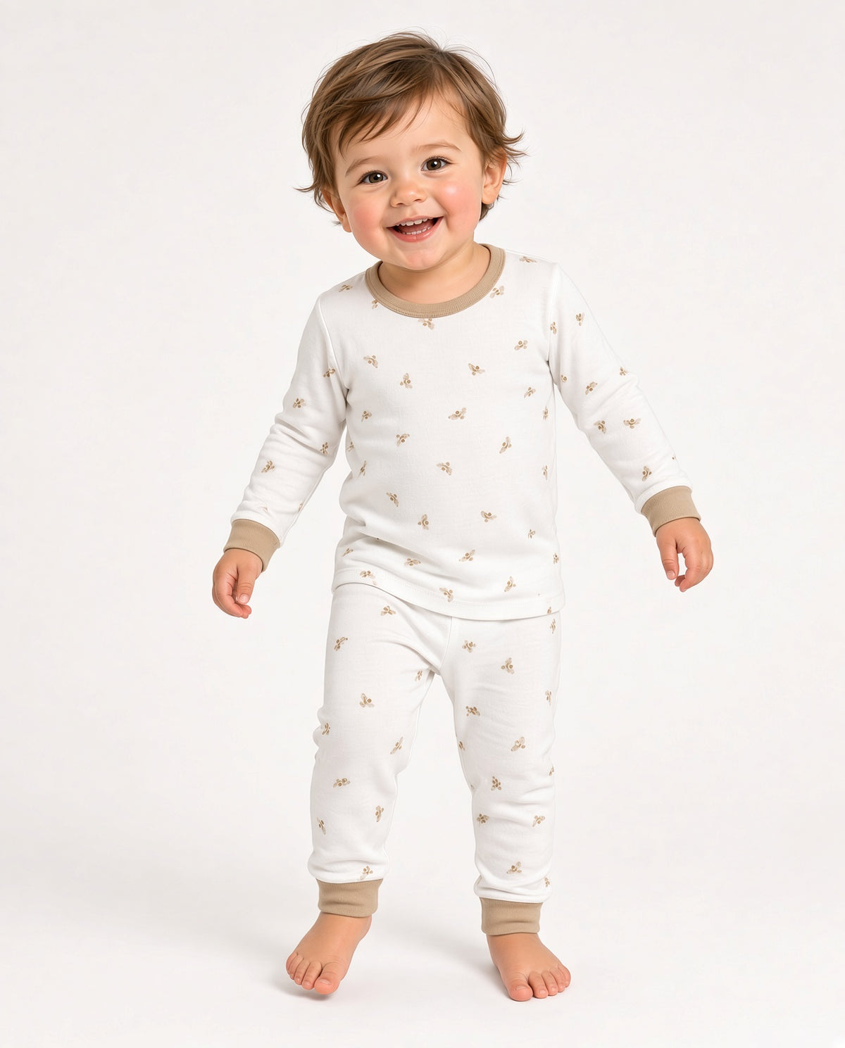 Toddler wearing a white two-piece long-sleeve pajama set with a small print