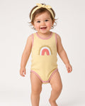 Baby wearing a yellow rainbow tank snap onesie with matching bow headband