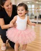 Toddler in a pink layered tulle tutu skirt at a dance studio