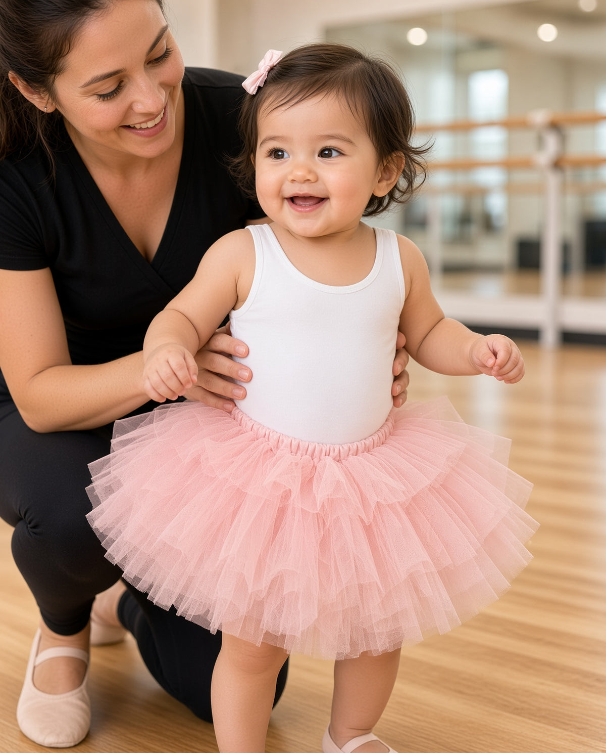 Toddler in a pink layered tulle tutu skirt at a dance studio