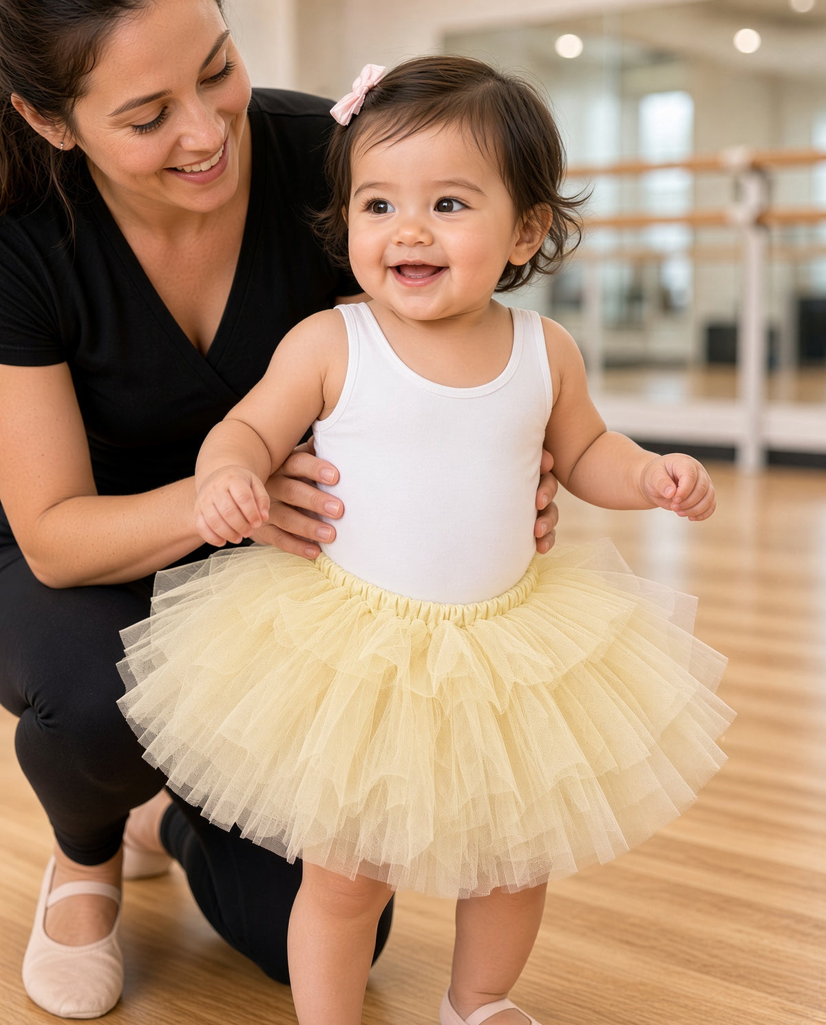Toddler in a light yellow layered tulle tutu skirt with a white top