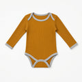 Mustard ribbed long-sleeve baby onesie with gray contrast trim, front view