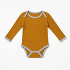 Mustard ribbed long-sleeve baby onesie with gray contrast trim, front view