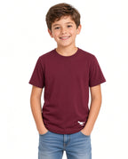 Boy wearing a burgundy solid tee with small dinosaur hem logo