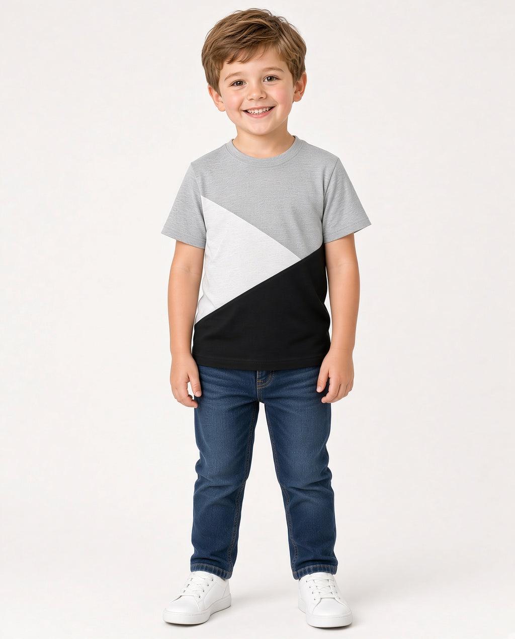 Boy wearing a gray, white, and black color block tee with jeans