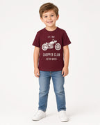 Boy wearing a burgundy Chopper Club Retro Bikes motorcycle tee and jeans
