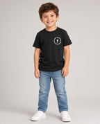 Boy wearing a black Little Rad Things Surf N Ride tee with small lightning bolt chest logo