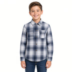 Boy wearing a navy and white plaid flannel button-up shirt