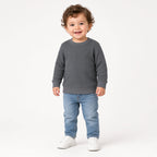 Toddler wearing a gray waffle knit long-sleeve crewneck with jeans