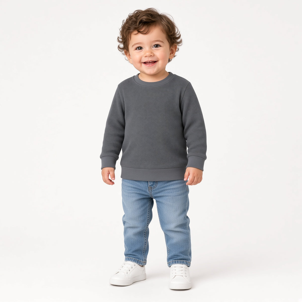 Toddler wearing a gray waffle knit long-sleeve crewneck with jeans