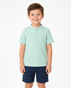 Boy wearing a mint green short-sleeve button placket shirt with navy shorts