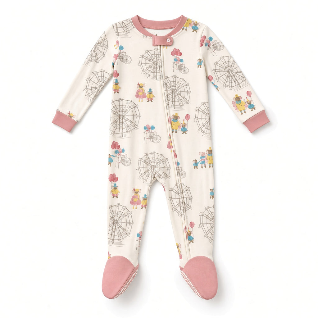 Cream baby footed zip sleeper with Ferris wheel carnival print and pink feet, front view