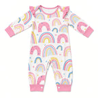 White baby romper with pastel rainbow print, ruffle shoulders, and pink cuffs, front view