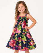 Girl in a navy floral smocked tiered sundress with square neckline