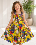 Girl twirling in a yellow floral smocked tiered sundress