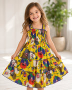 Girl twirling in a yellow floral smocked tiered sundress