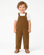 Toddler wearing camel corduroy overalls with a white tee