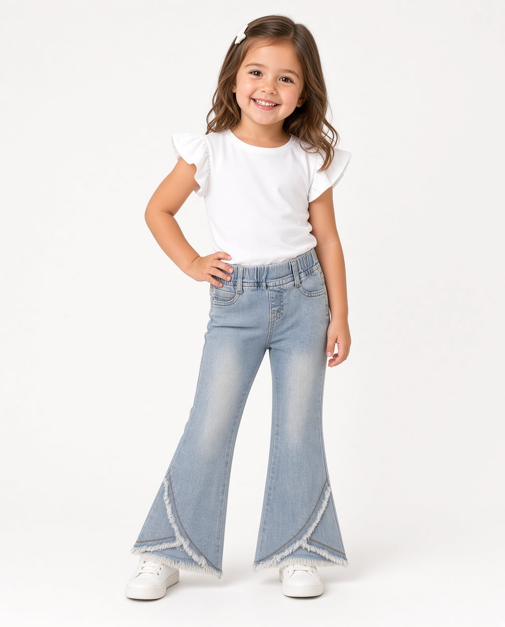 Girl wearing light-wash bell-bottom jeans with frayed split hem and a white tee