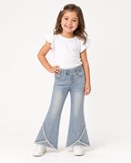 Girl wearing light-wash bell-bottom jeans with frayed split hem and a white tee