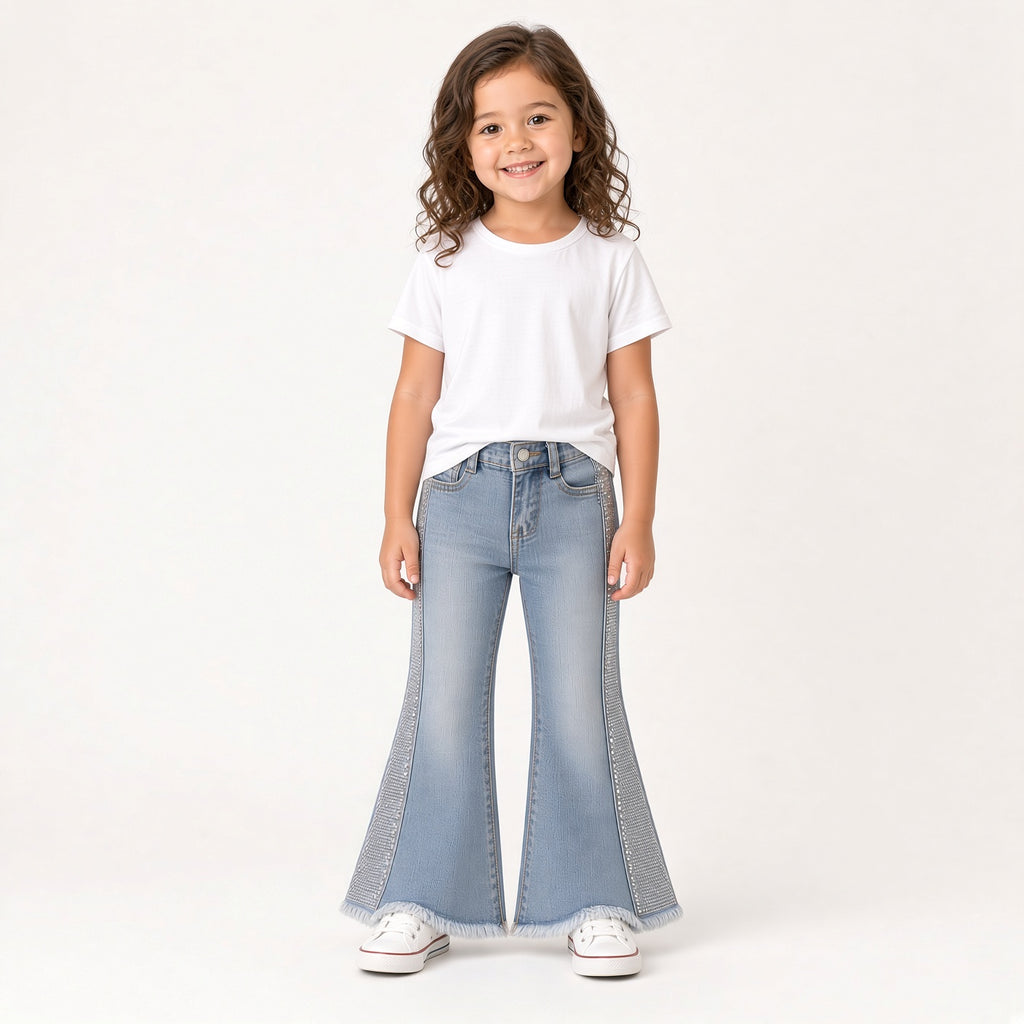 Girl wearing light-wash sequin bell-bottom jeans with a white tee
