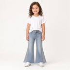 Girl wearing light-wash sequin bell-bottom jeans with a white tee