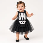 Baby wearing a black skeleton print tutu romper for Halloween