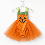 Orange pumpkin tutu romper with jack-o-lantern face and green straps on a hanger