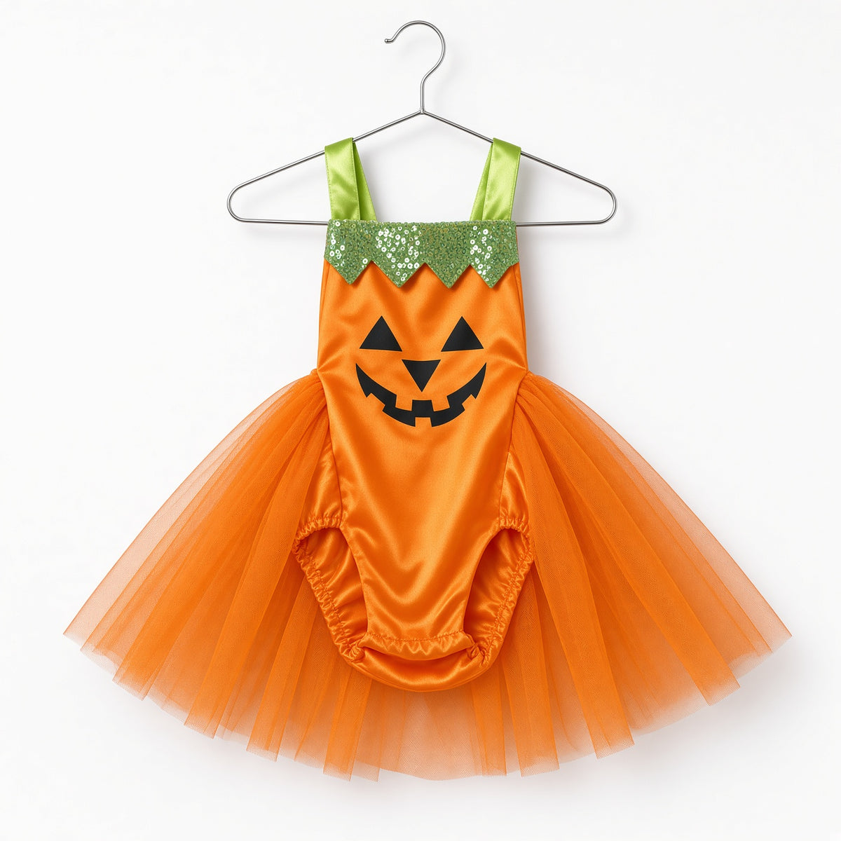 Orange pumpkin tutu romper with jack-o-lantern face and green straps on a hanger