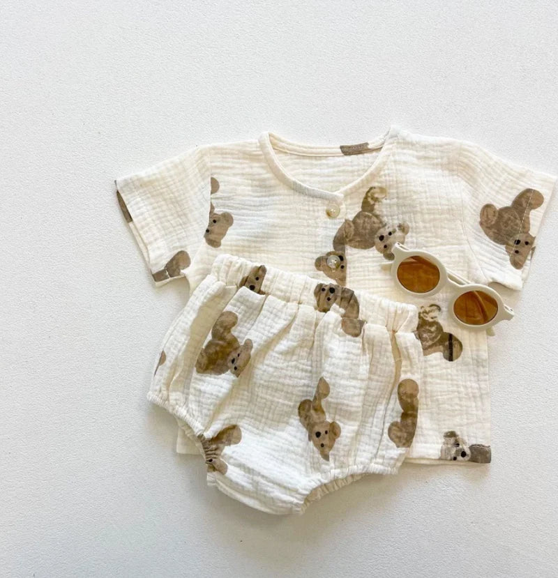 Cream muslin teddy bear print short-sleeve shirt and bloomers set, styled flat lay