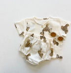 Cream muslin teddy bear print short-sleeve shirt and bloomers set, styled flat lay