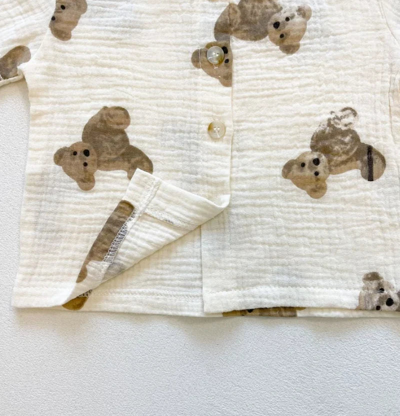 Close-up of crinkle muslin fabric with brown teddy bear print and button front