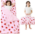 Kids on a pink strawberry print toddler nap mat with pillow and minky blanket, and rolled up with handle