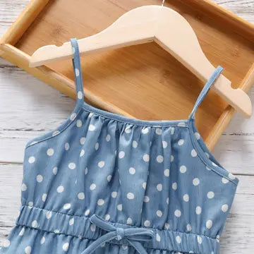 Close-up of blue polka dot jumpsuit bodice with thin straps and drawstring tie waist