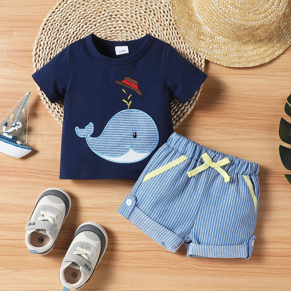 Navy short-sleeve whale appliqué shirt with light blue striped shorts, two-piece set