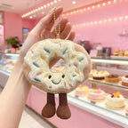 Sprinkle donut plush keychain charm with smiling face and corduroy legs