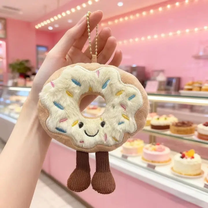 Sprinkle donut plush keychain charm with smiling face and corduroy legs