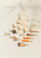 Wooden ice cream playset pieces laid out: stand, cones, scoops, and popsicles