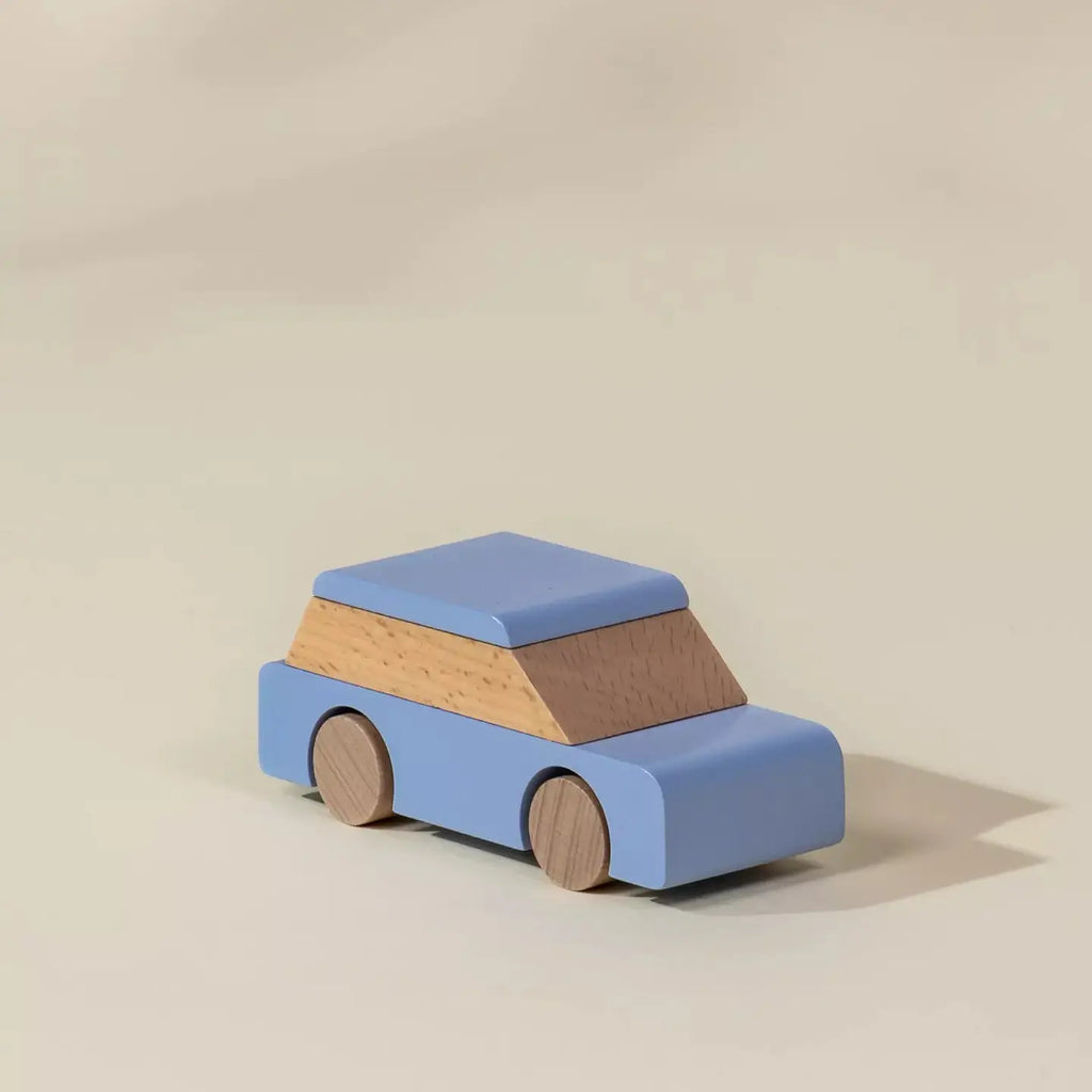 Blue wooden city car toy with natural wood cabin, angled view